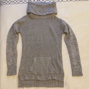 Grey sweater, with turtleneck.